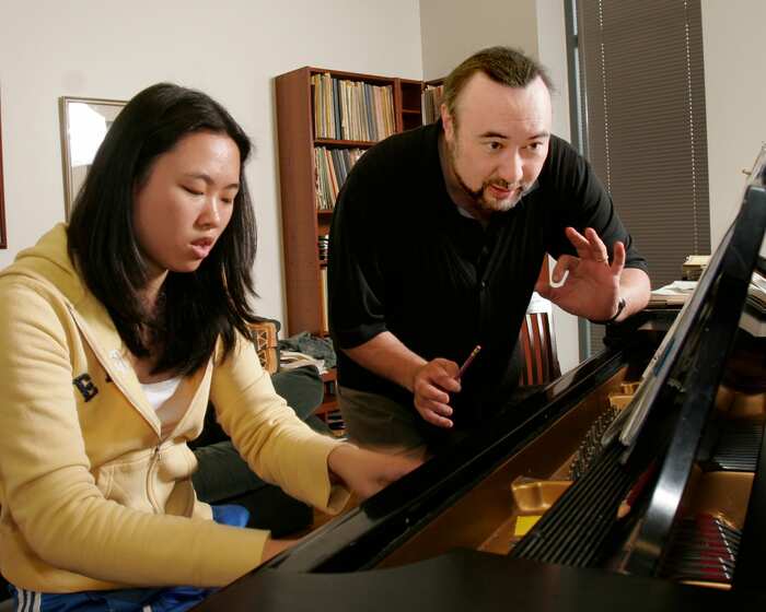 Mr. Parker conducting piano lesson with student.